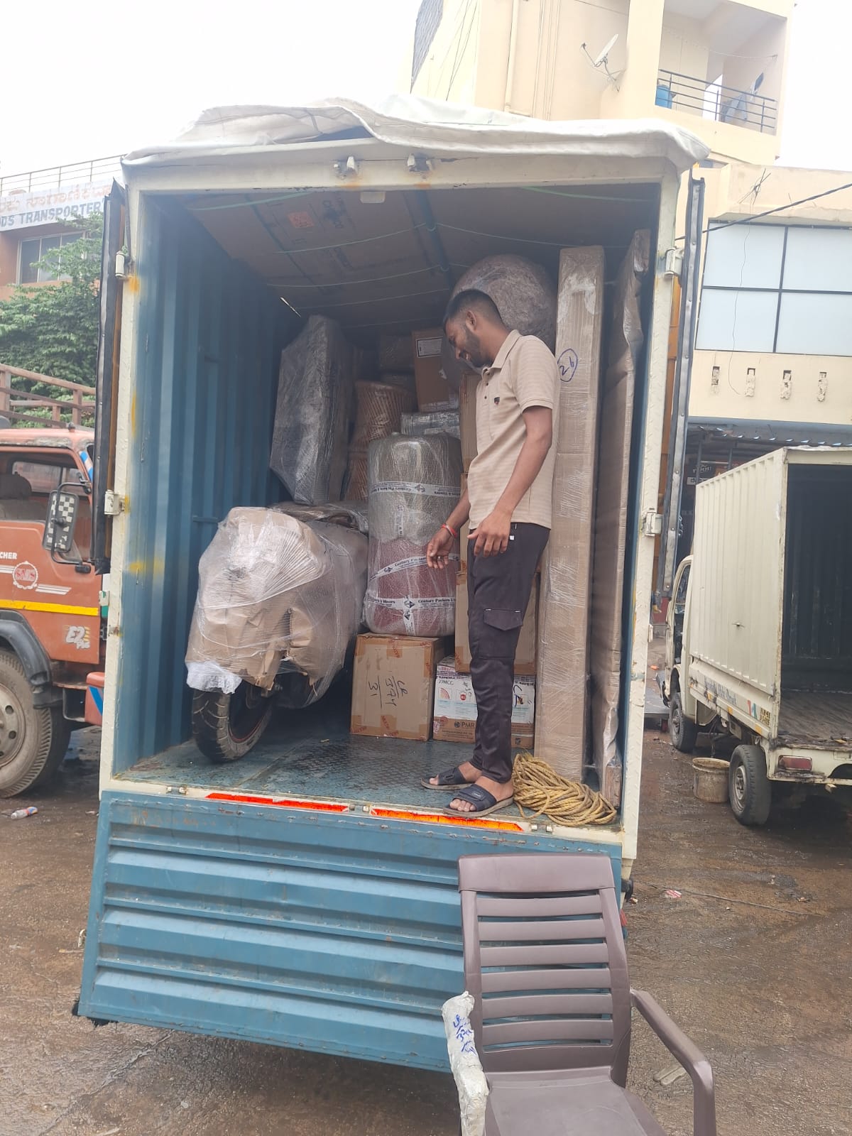 Moving team loading packed household goods into a transport truck in Bangalore